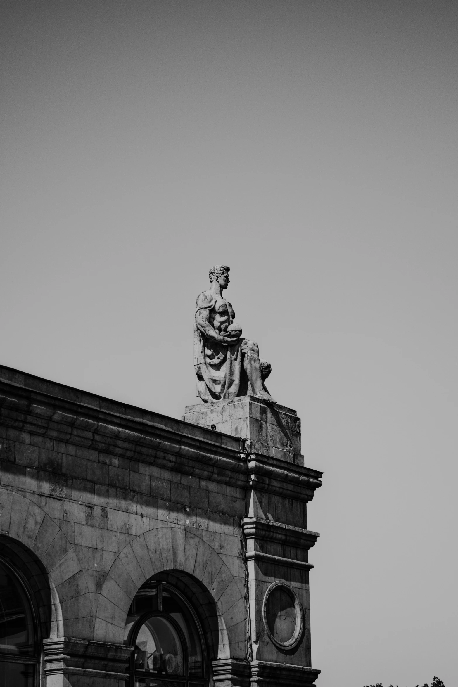 a black and white po of a building with a statue on top