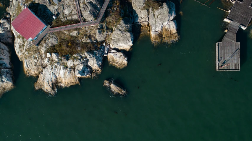 aerial view of pier and red roof over water