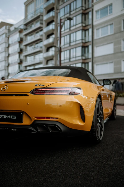 a car is parked in front of tall buildings