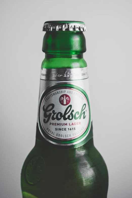 a large green bottle of girbaich beer sitting on top of a counter