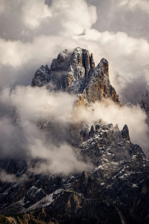 mountains with snow covered clouds above them