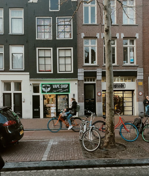 people and their bikes are parked on the sidewalk