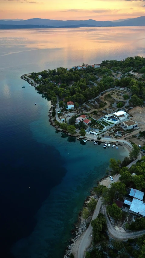 an aerial view of a village on the shoreline