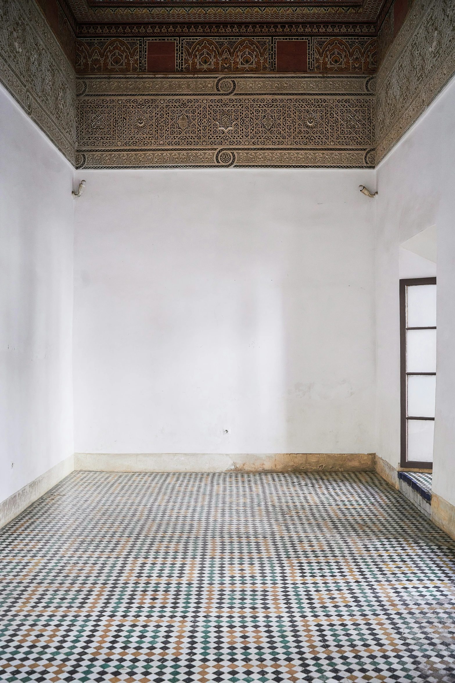 an empty room with a window and a rug