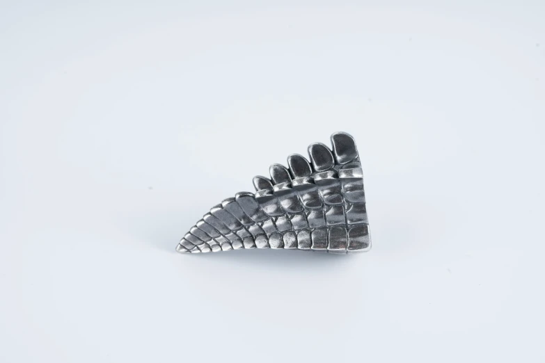this is a silver metal ring with spikes