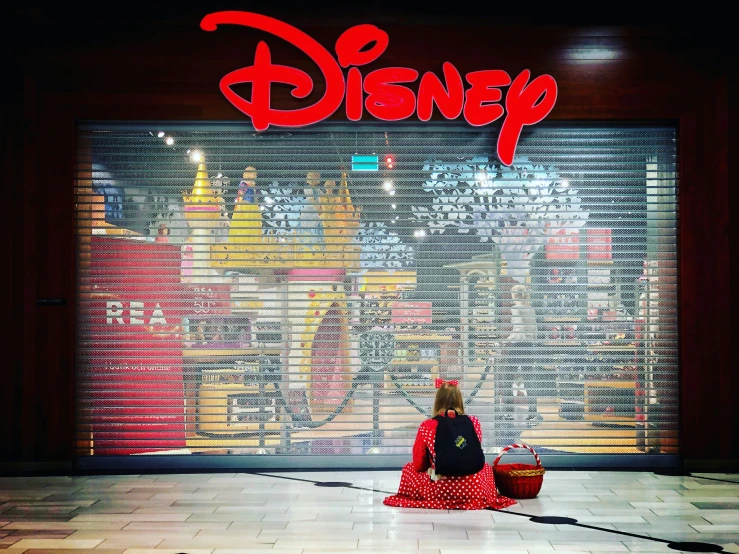 woman in front of disney store with window blinds