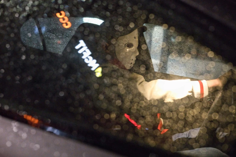 a side mirror view of a man holding an umbrella