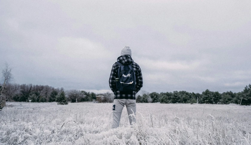 a man standing in a snow covered field