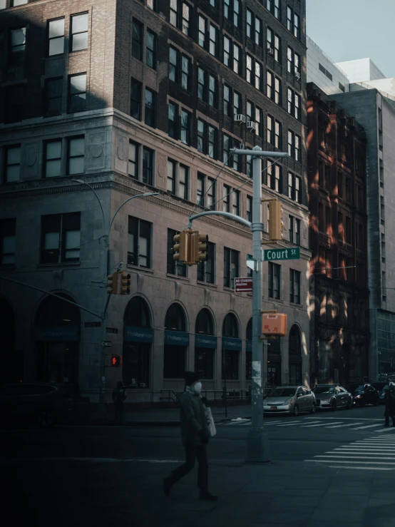 a city street that has people walking and cars on the street