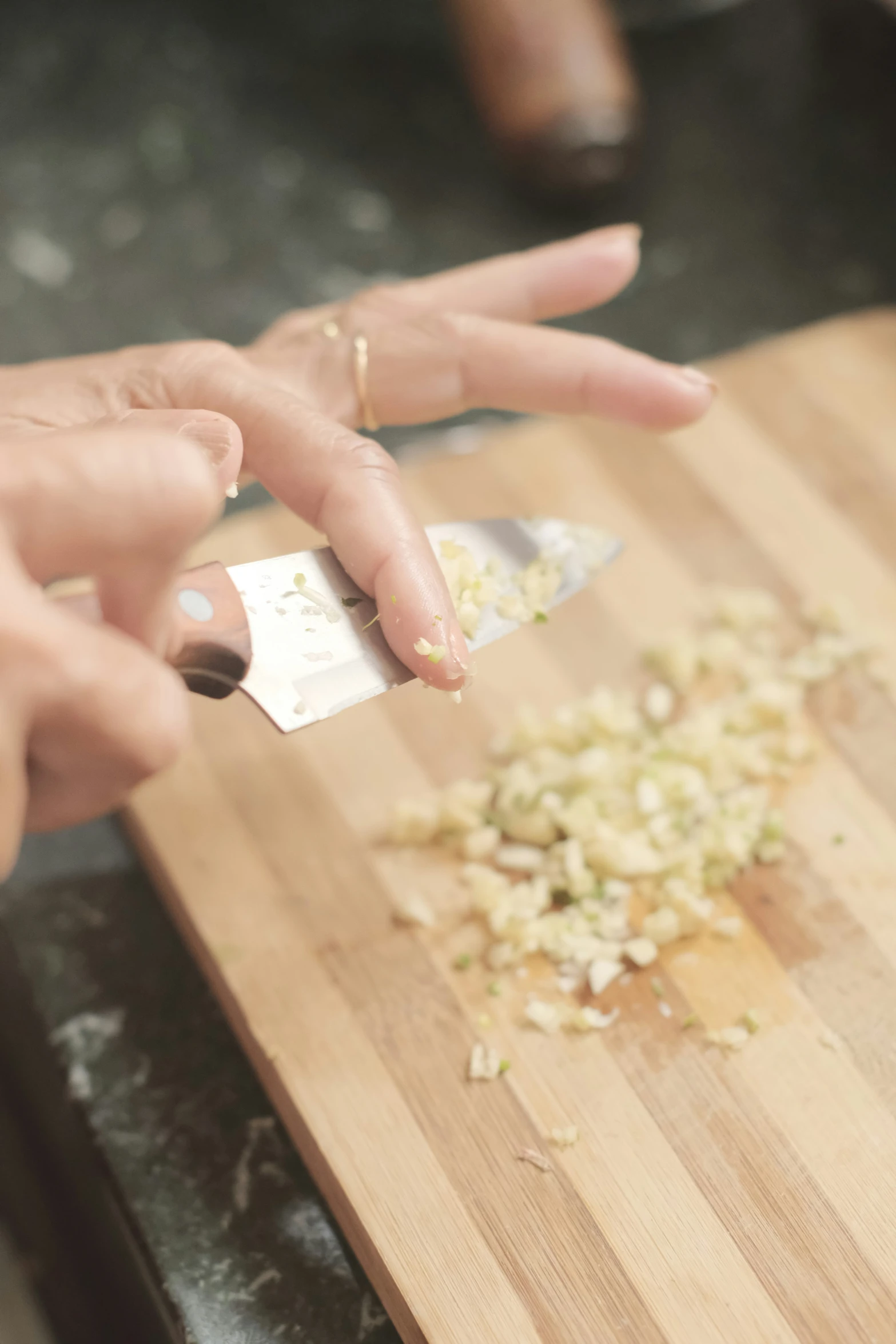 a person  up some onions on top of a  board