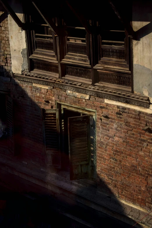 a building with a closed window and brick wall