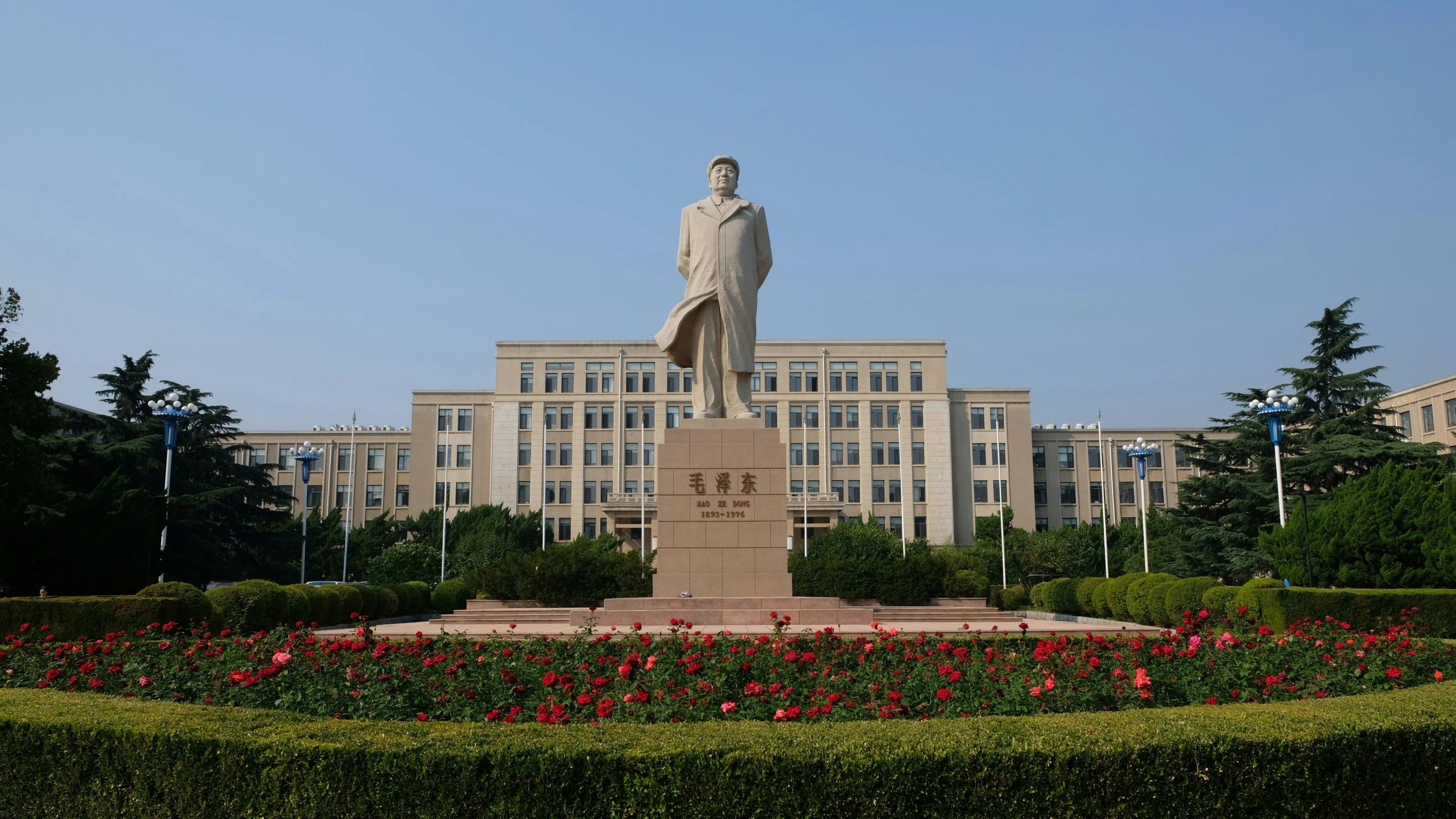 a big white statue with a clock at the top