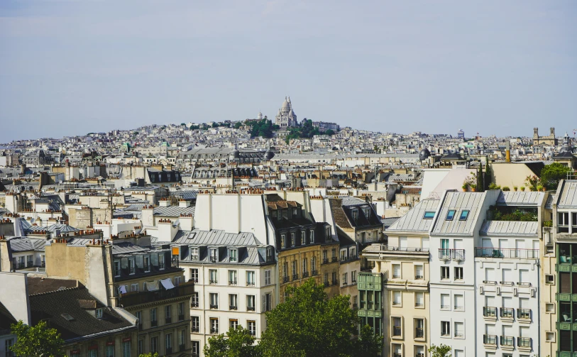 large white buildings with city in back and sky