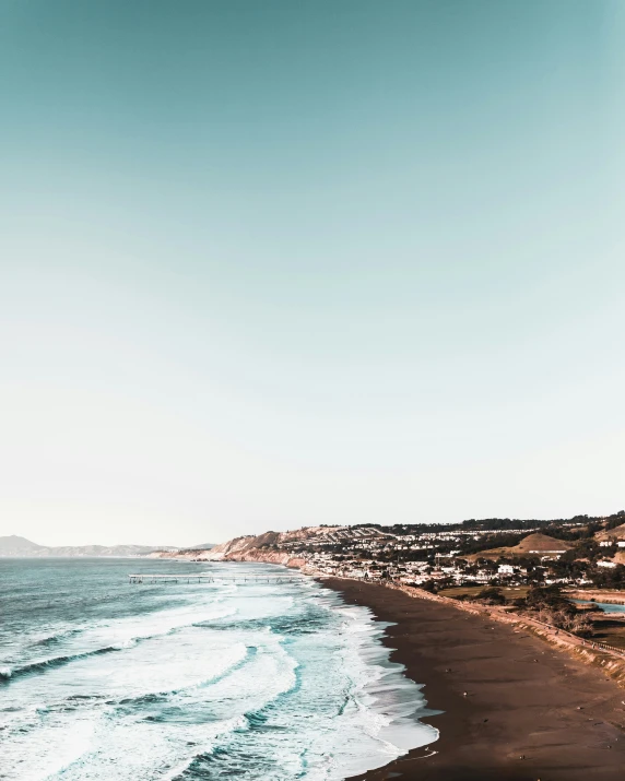 a body of water next to a sandy beach