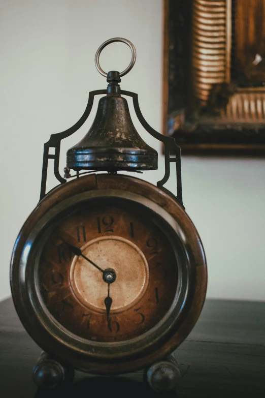 the old time clock is next to the painting