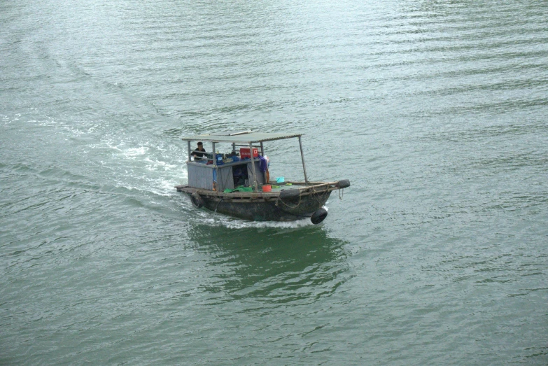 the small boat is carrying several passengers in the water