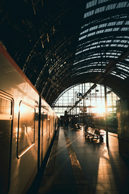 the inside of a train station at sunrise