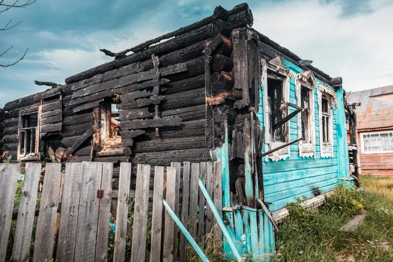 the old, run down wooden house is partially rusted