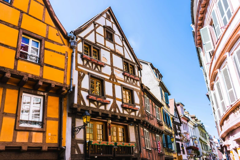 the street is lined with colorful old buildings