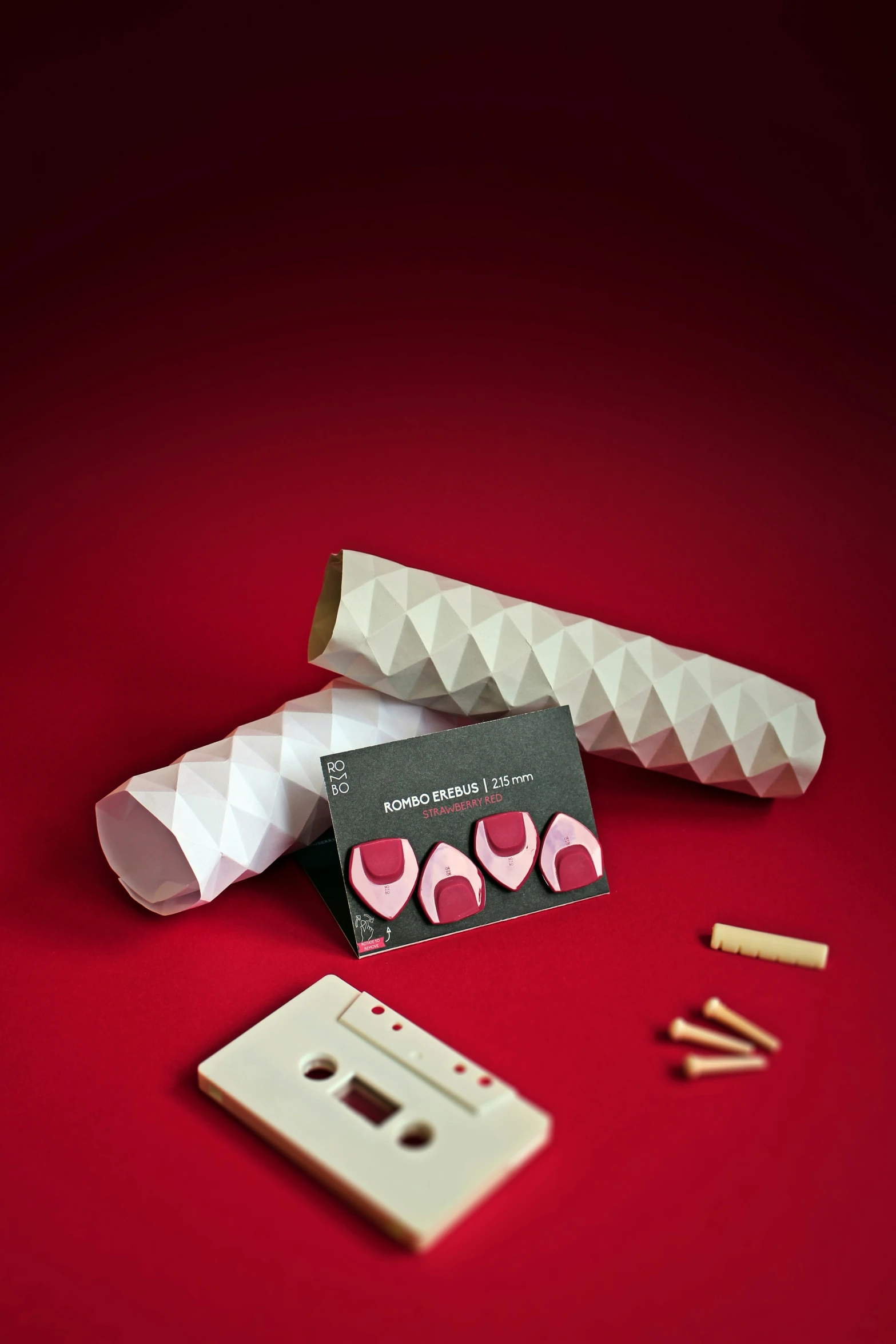 a white tape and some other objects on a red surface