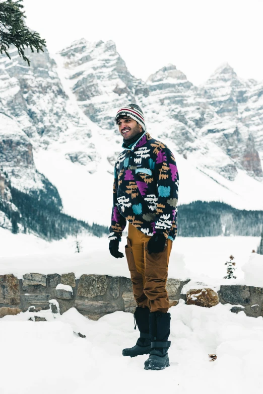 a man wearing snow boots while standing in the snow