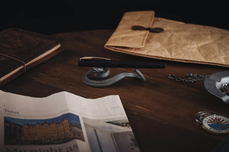 a book, a magnifying glass and other items sit on a table