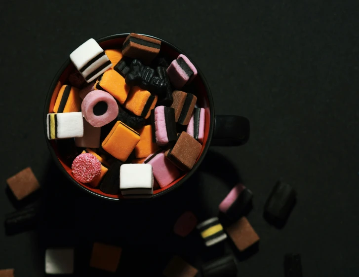 a small glass filled with assorted candies
