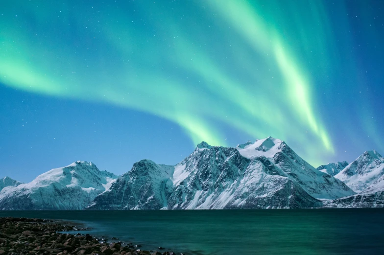 a green aurora aurora in the sky over a lake