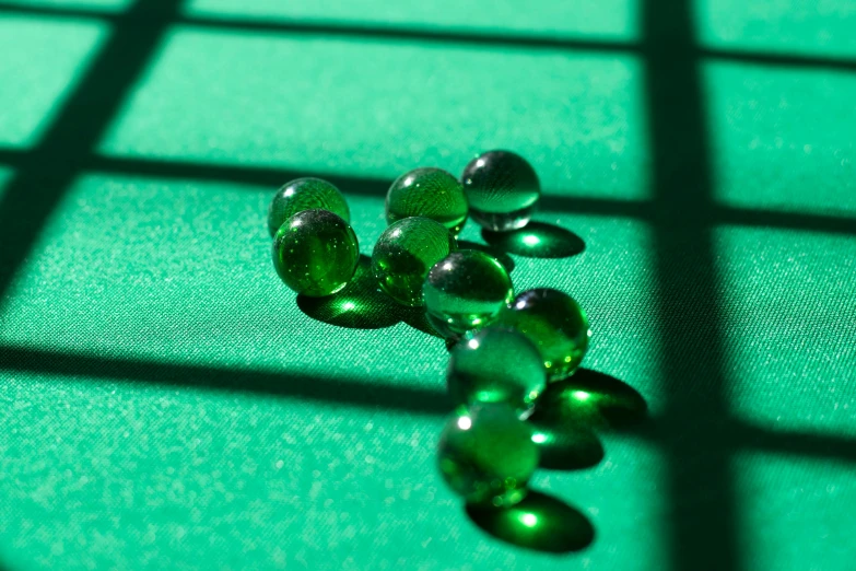 several different glass beads on a green background