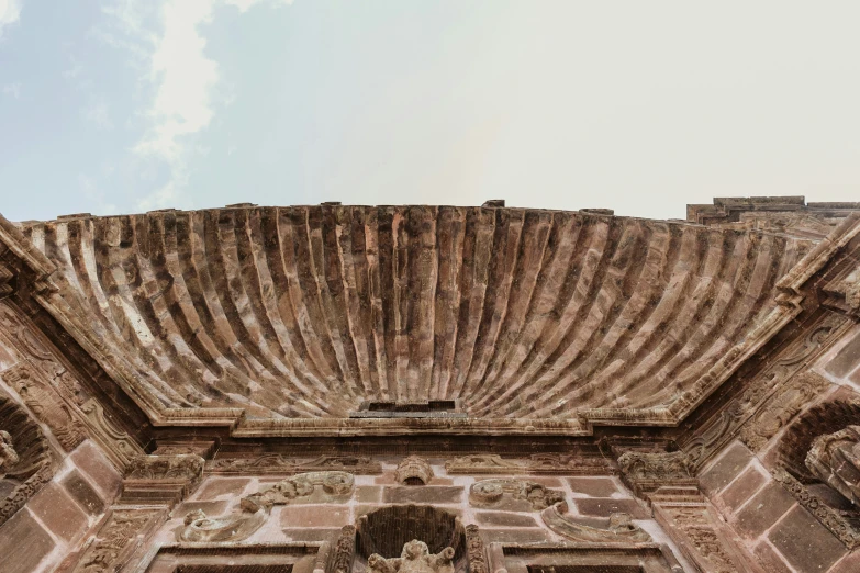 a view from below of a brown and white building