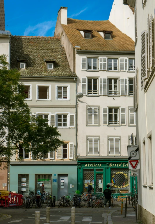 several bicycles and some people near a street