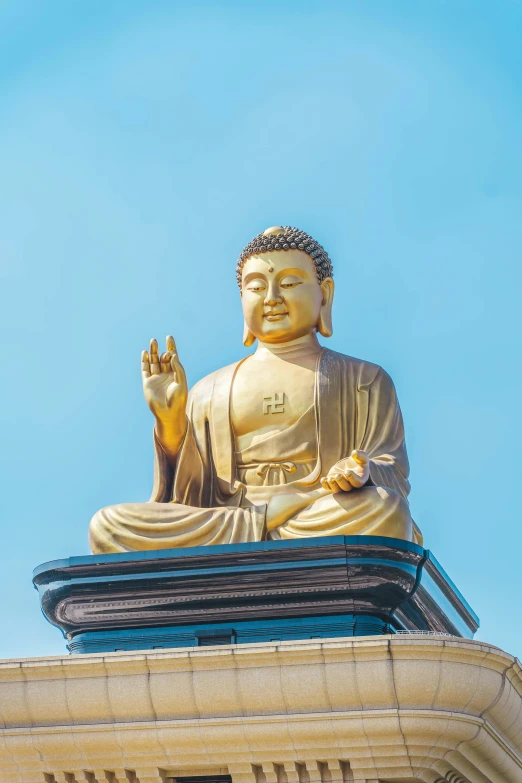 large buddha statue in front of a blue sky