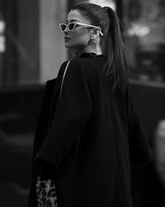 a woman with long hair walking down the street