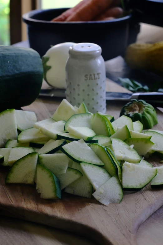 a  board topped with sliced vegetables on top of a table