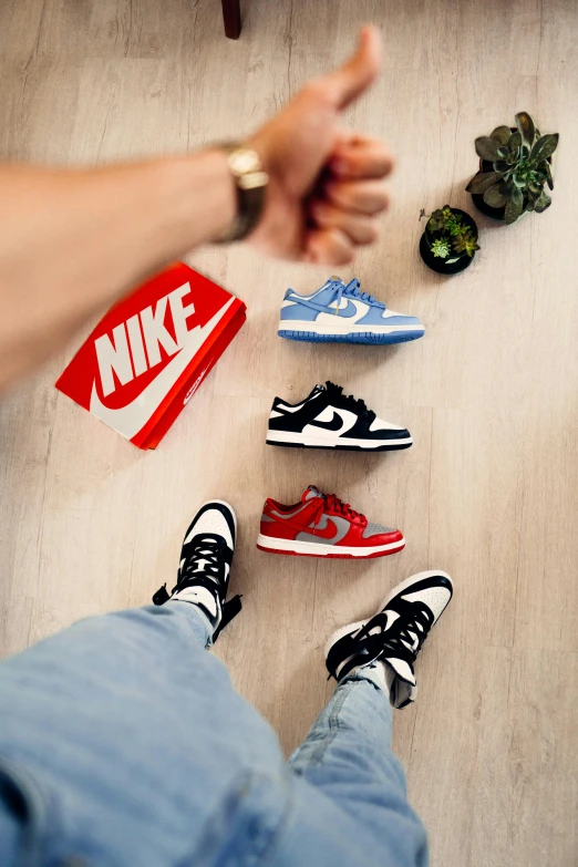 various sneakers and a box on a floor