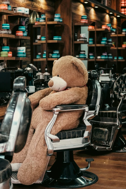 a big teddy bear sitting in a salon chair