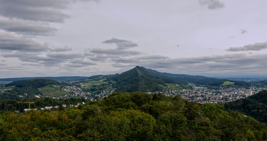 a town sits on top of a high hill in the woods