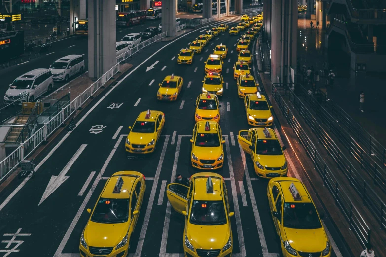 a group of yellow taxis sitting next to each other