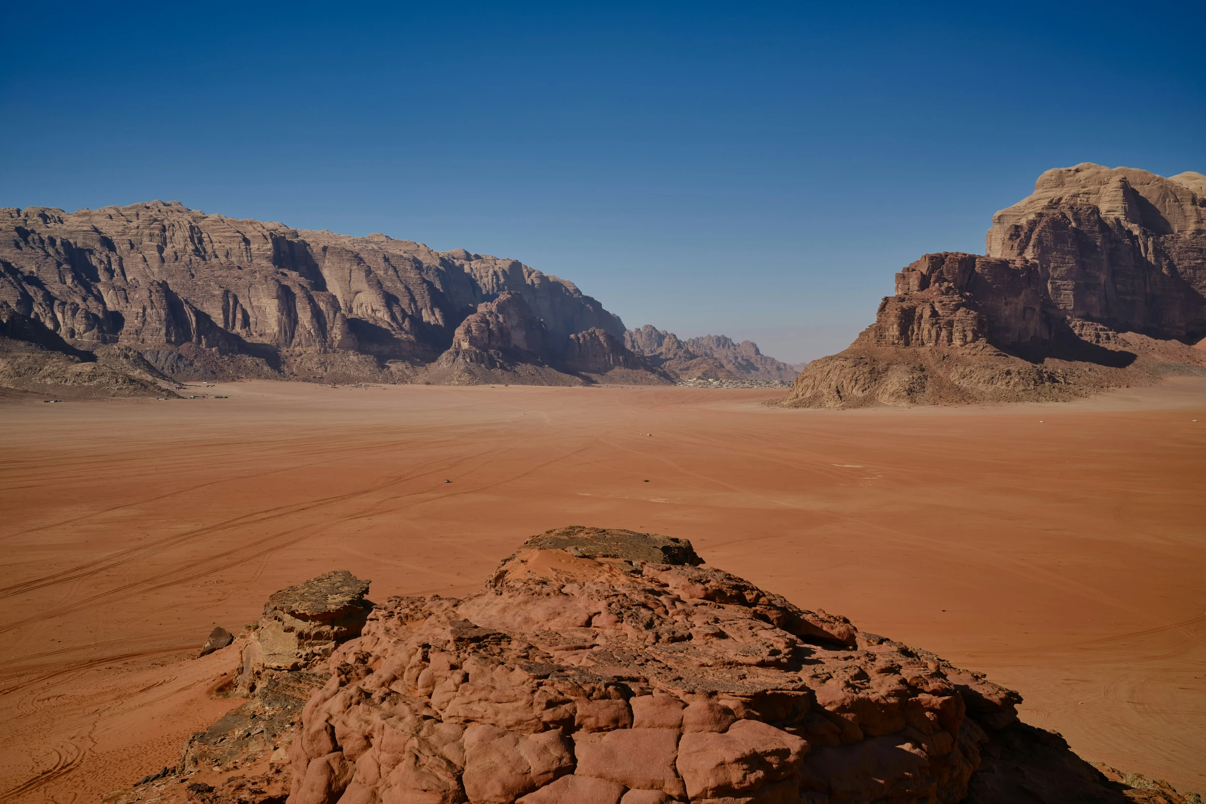 a desert scene with mountains and sand