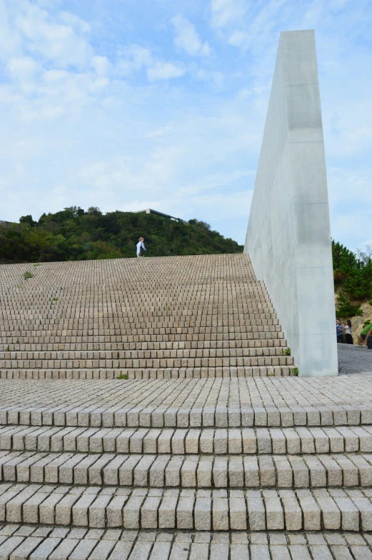 a man is standing next to a cement slab