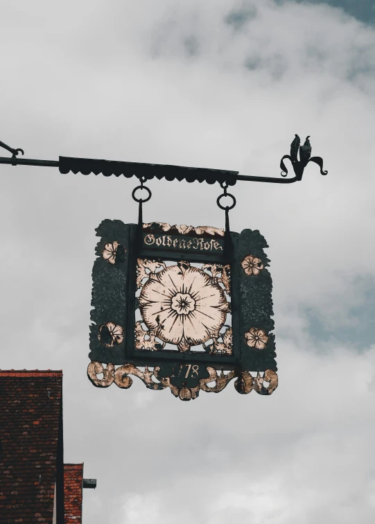 there is a clock hanging from the roof