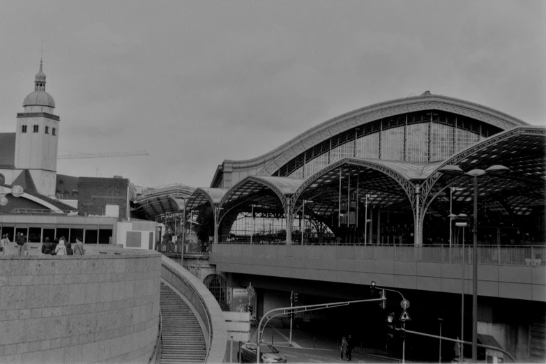 an old black and white po of people in front of a train station