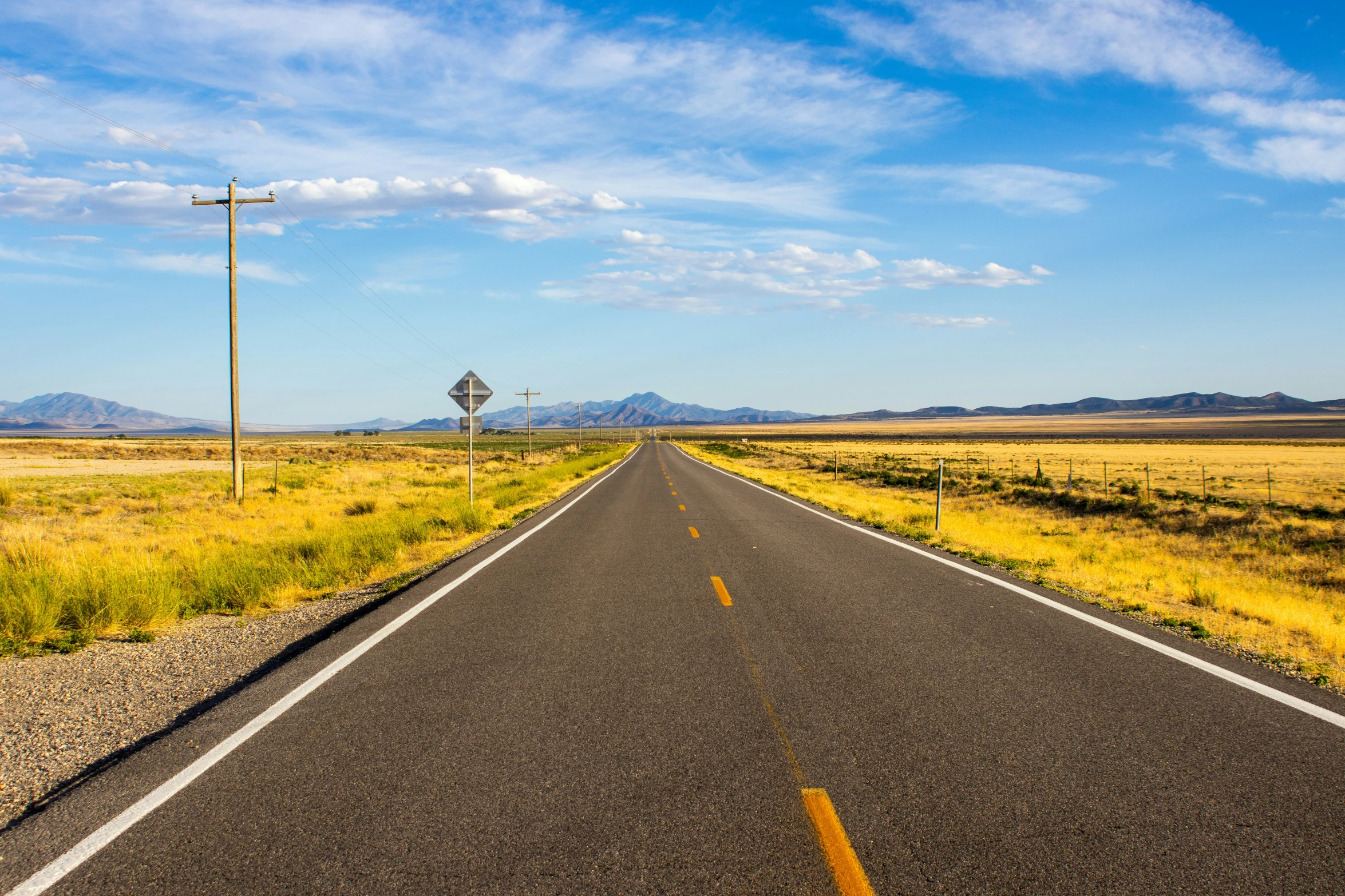 an empty road in the middle of a desert