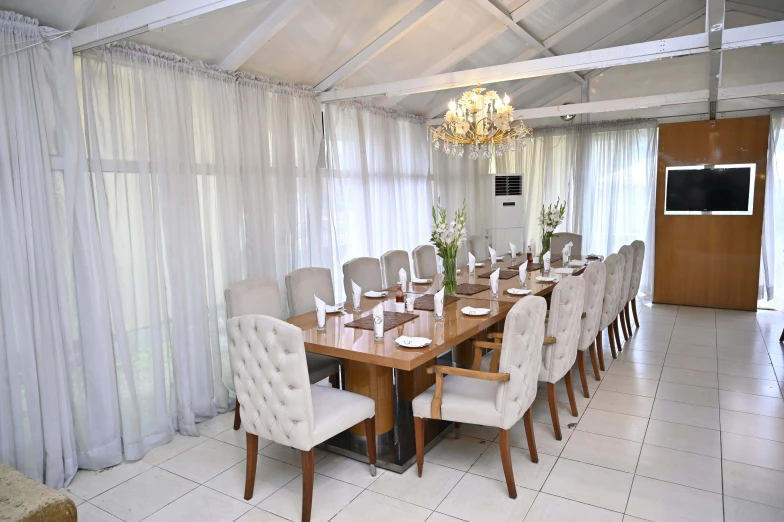 the large dining room is decorated in white