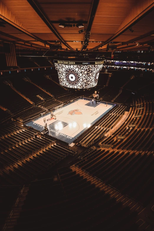 an indoor basketball court with a big crowd in it