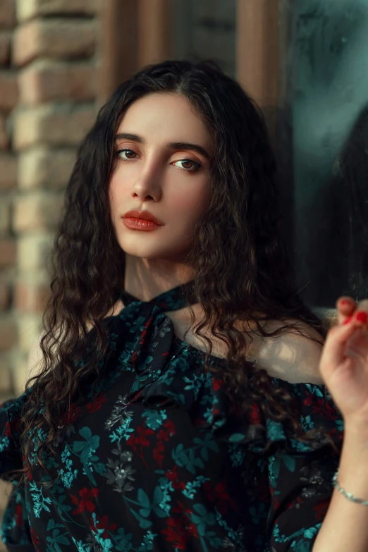 a woman in a black floral blouse is smoking