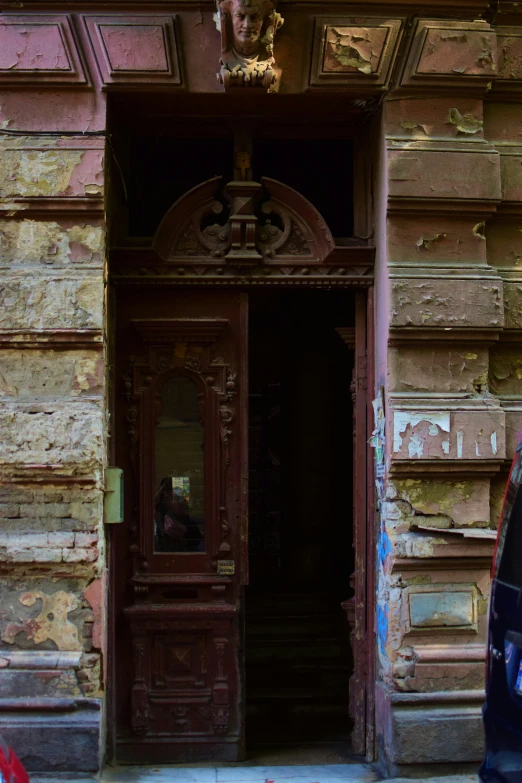 a man sitting in the doorway to an old wooden building