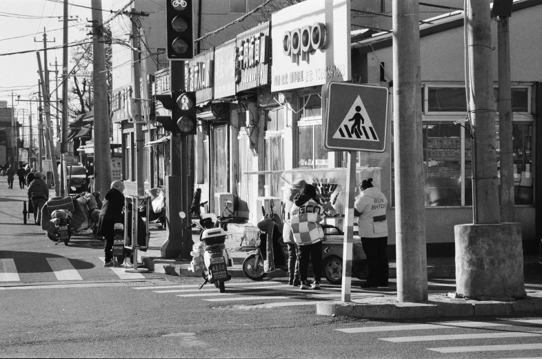 a line of people waiting to cross the street