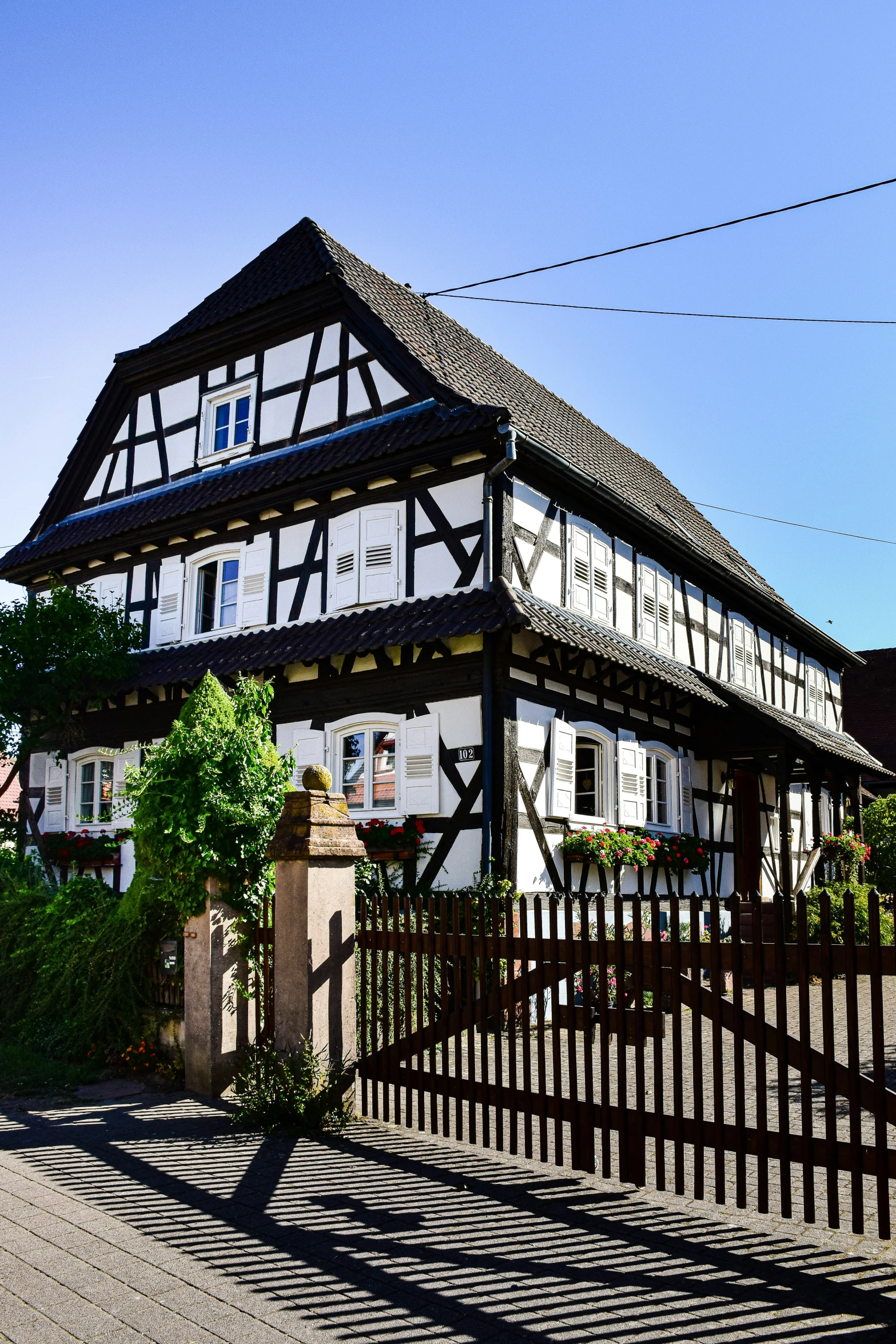 this house has two towers and is near a street corner