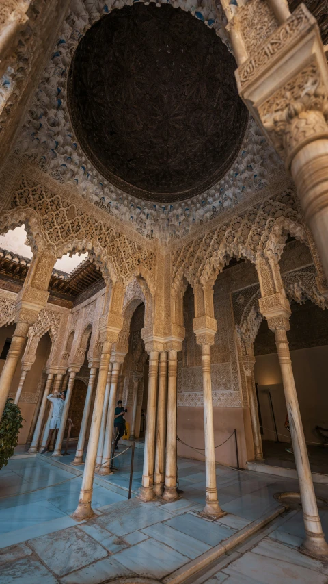 the inside of a palace with many arches and pillars